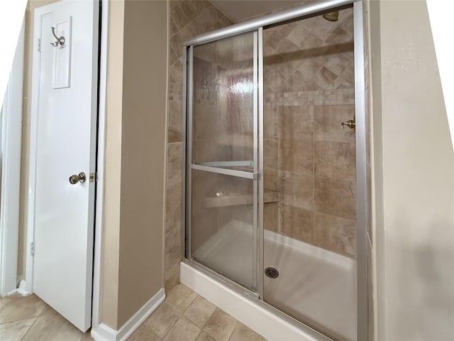 bathroom with tile patterned floors and a shower with shower door