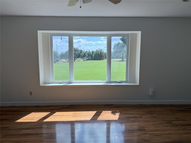 empty room with dark wood-type flooring and ceiling fan