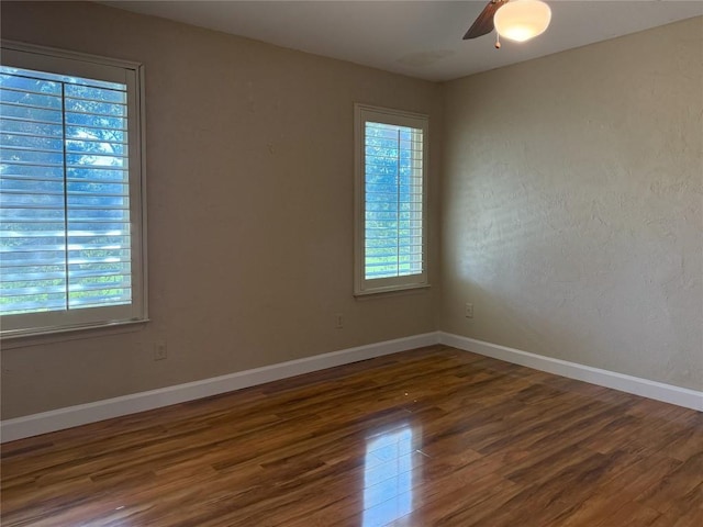 unfurnished room featuring ceiling fan and dark hardwood / wood-style floors