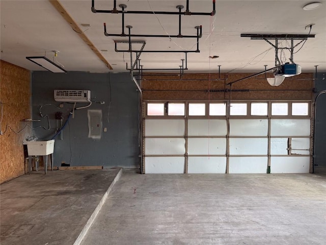 garage with electric panel, a garage door opener, and sink