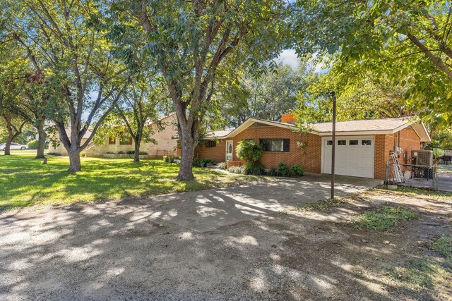 ranch-style home featuring a front lawn and a garage