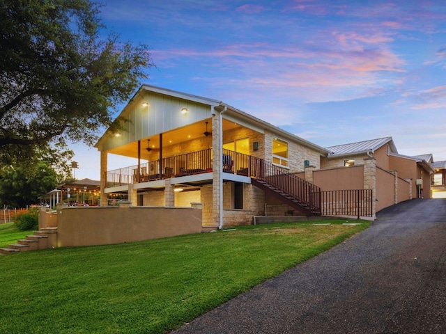 exterior space featuring a lawn and a balcony