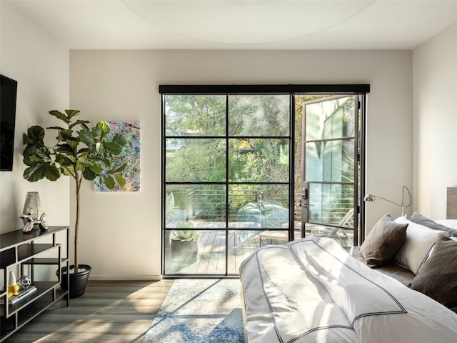 bedroom with wood-type flooring and multiple windows