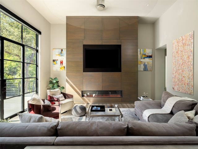 living room featuring hardwood / wood-style flooring and a tiled fireplace