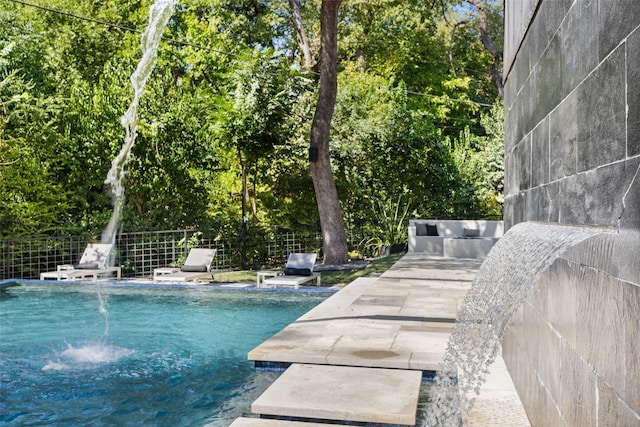 view of pool featuring pool water feature