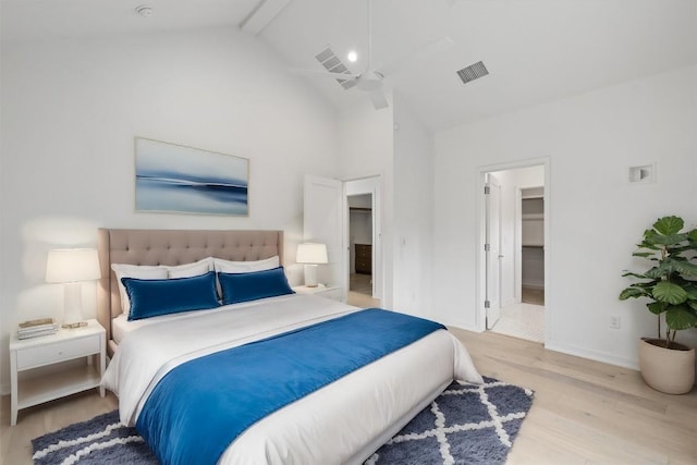 bedroom with ceiling fan, high vaulted ceiling, light hardwood / wood-style flooring, a spacious closet, and beamed ceiling