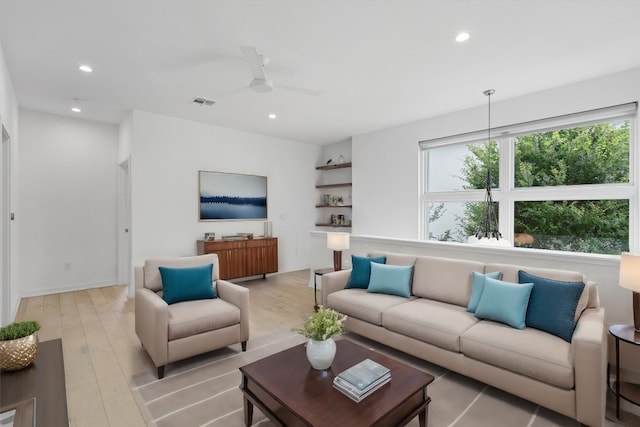 living area featuring light wood-type flooring, visible vents, and recessed lighting