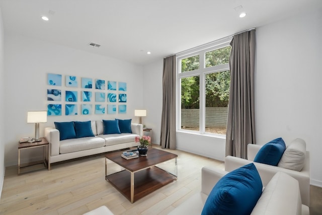 living room featuring recessed lighting, visible vents, and light wood finished floors