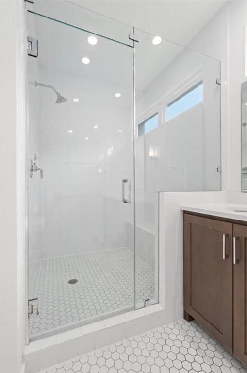 bathroom featuring recessed lighting, a shower stall, and vanity