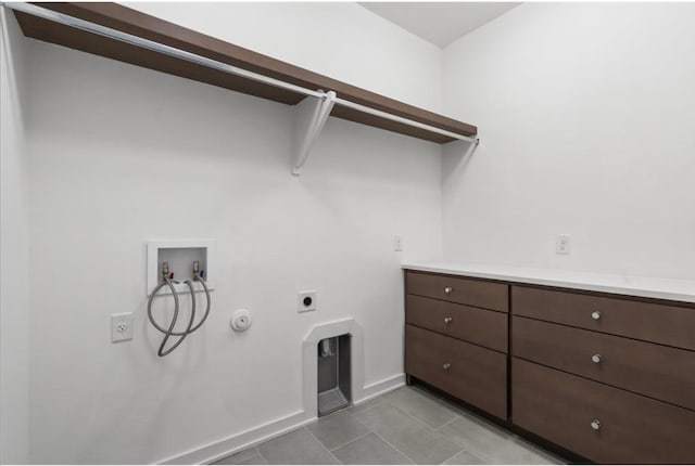 clothes washing area with washer hookup, hookup for an electric dryer, gas dryer hookup, and light tile patterned floors