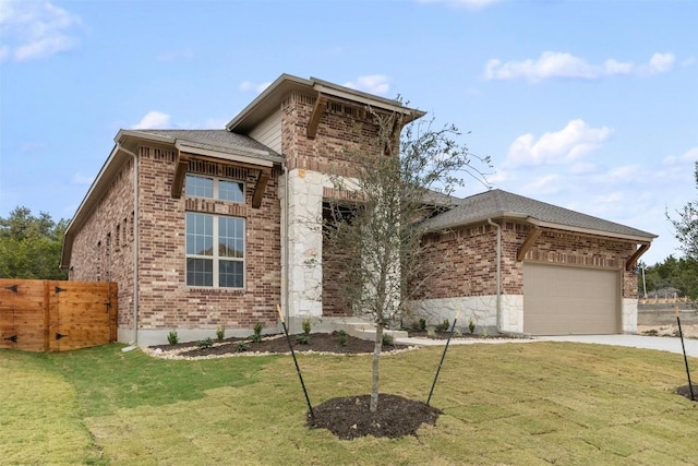 view of front of house featuring a front yard and a garage