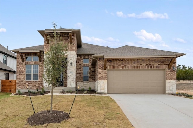 view of front of property featuring a front yard and a garage