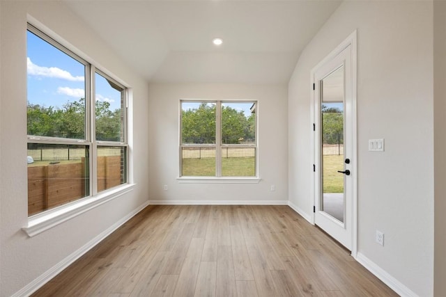 unfurnished sunroom with a healthy amount of sunlight and lofted ceiling