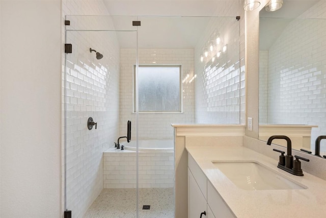 bathroom featuring separate shower and tub and vanity