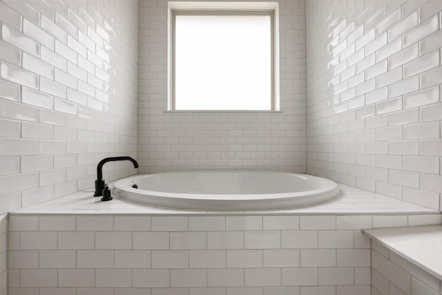 bathroom with tiled bath