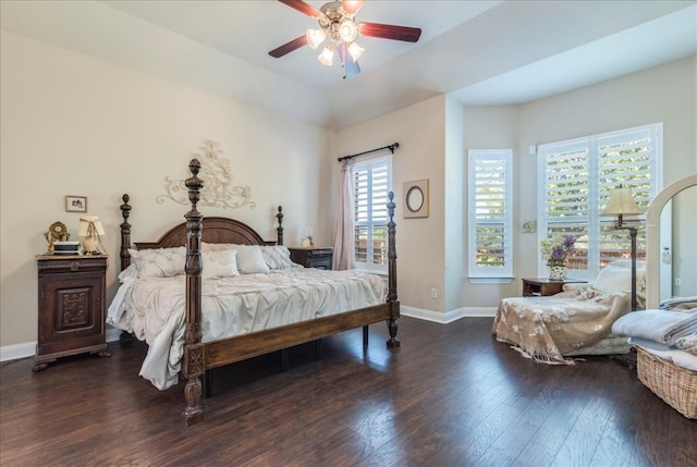 bedroom with ceiling fan, dark hardwood / wood-style flooring, and multiple windows