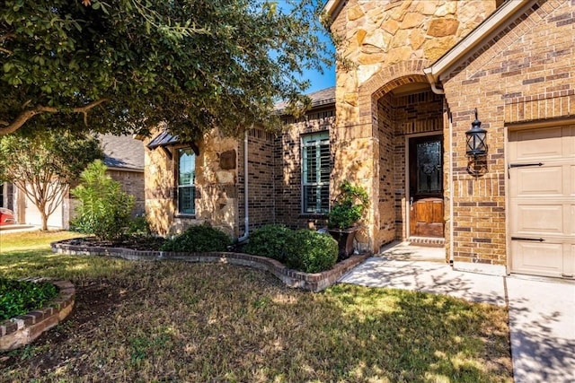 view of exterior entry with a garage