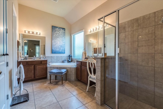 bathroom featuring shower with separate bathtub, vanity, tile patterned floors, and lofted ceiling