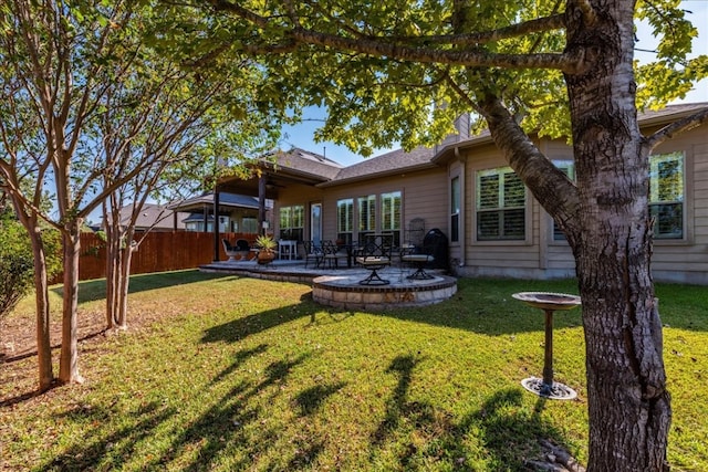 back of property featuring a yard and a patio