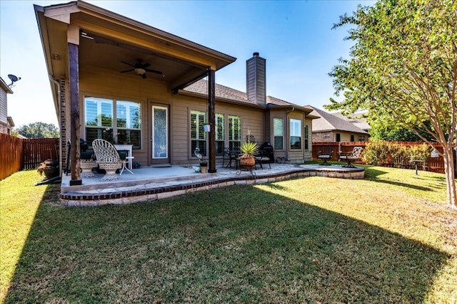 back of house with a patio, ceiling fan, and a lawn