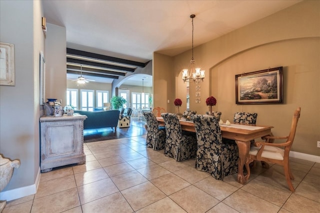 dining room featuring beam ceiling, ceiling fan with notable chandelier, and light tile patterned flooring