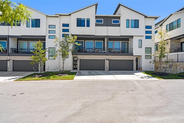 2050 Lohmans Spur Unit 603, Austin, TX 78734 - contemporary home with stucco siding, a garage, and driveway