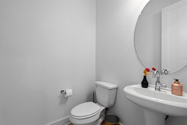 2050 Lohmans Spur Unit 603, Austin, TX 78734 - half bathroom with a sink, toilet, and baseboards