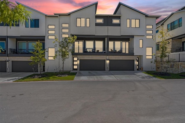 2050 Lohmans Spur Unit 603, Austin, TX 78734 - modern home with stucco siding, a garage, and driveway