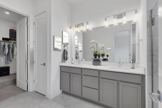 2050 Lohmans Spur Unit 603, Austin, TX 78734 - full bath featuring double vanity, marble look tiles, a spacious closet, and baseboards