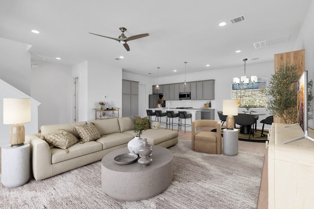 living area featuring light wood-type flooring, visible vents, and recessed lighting