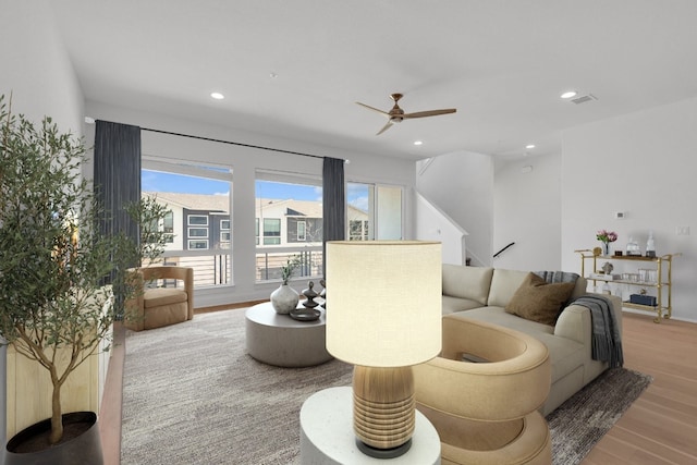 2050 Lohmans Spur Unit 603, Austin, TX 78734 - living room featuring wood finished floors, a ceiling fan, recessed lighting, and stairs