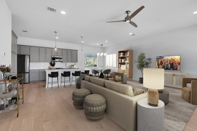2050 Lohmans Spur Unit 603, Austin, TX 78734 - living room featuring light wood-style floors, ceiling fan, recessed lighting, and a chandelier