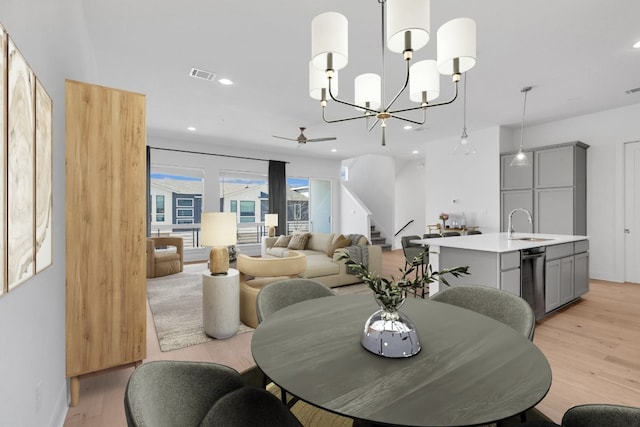 2050 Lohmans Spur Unit 603, Austin, TX 78734 - dining room with light wood finished floors, stairway, ceiling fan, recessed lighting, and a chandelier