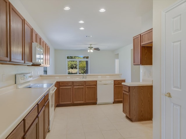 kitchen with ceiling fan, kitchen peninsula, and white appliances