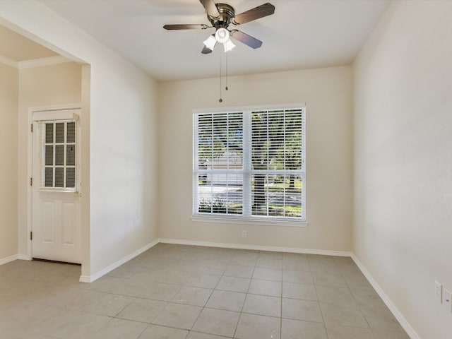 spare room featuring ceiling fan and light tile patterned floors