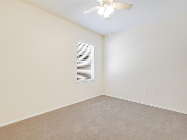 spare room featuring light carpet and ceiling fan