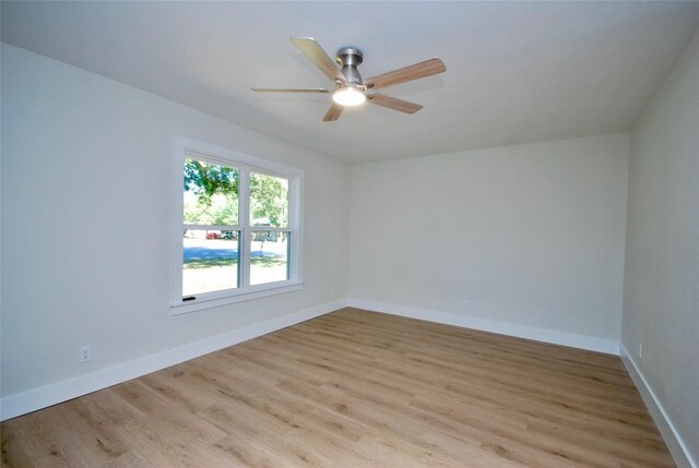 316 N Penn St, Flatonia, TX 78941 - empty room featuring light wood finished floors, ceiling fan, and baseboards