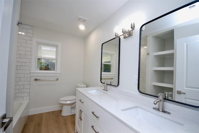 316 N Penn St, Flatonia, TX 78941 - bathroom with double vanity, toilet, wood finished floors, shower / tub combination, and baseboards