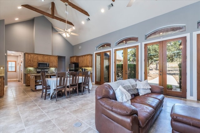 tiled living room with beam ceiling, ceiling fan, french doors, and high vaulted ceiling