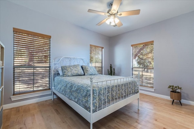 bedroom with wood-type flooring and ceiling fan