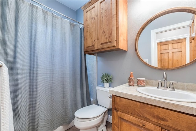 bathroom featuring walk in shower, vanity, and toilet