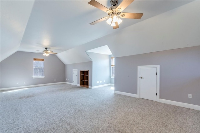 additional living space featuring carpet, lofted ceiling, and ceiling fan