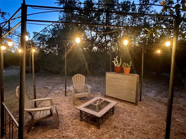 yard at dusk with a fire pit