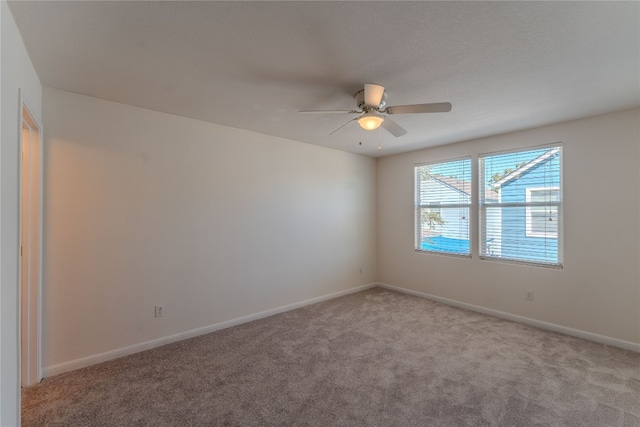 unfurnished room featuring ceiling fan and light colored carpet