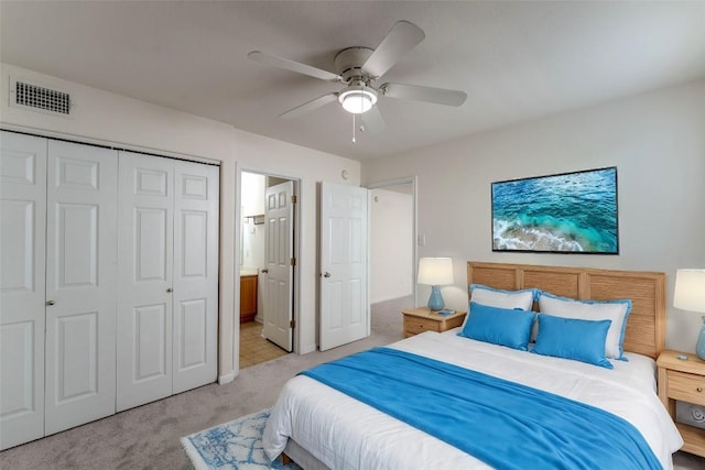 418 Shadow Pt, San Marcos, TX 78666 - bedroom featuring a closet, light carpet, ensuite bath, a ceiling fan, and visible vents