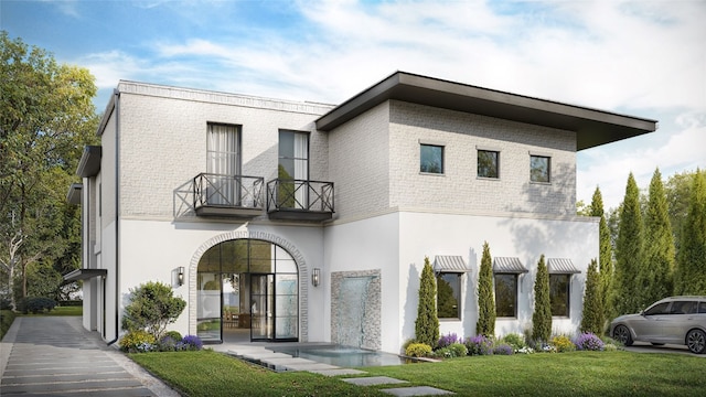 view of front of property featuring a balcony and a front lawn