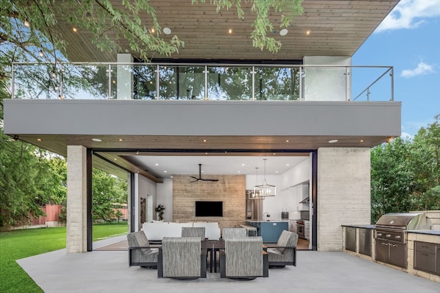 view of patio / terrace featuring area for grilling, an outdoor stone fireplace, and a grill