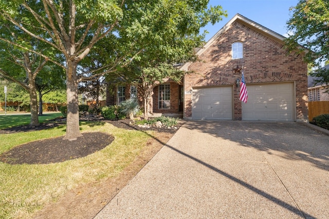 view of front of home with a front yard and a garage