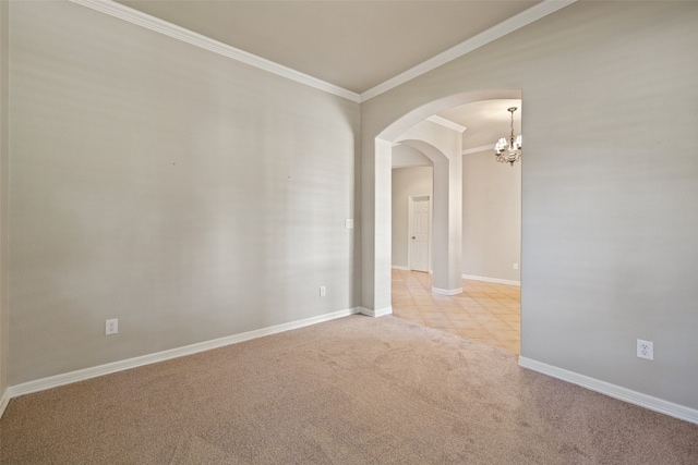 carpeted spare room with ornamental molding and a notable chandelier