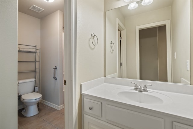 bathroom featuring vanity, tile patterned flooring, and toilet